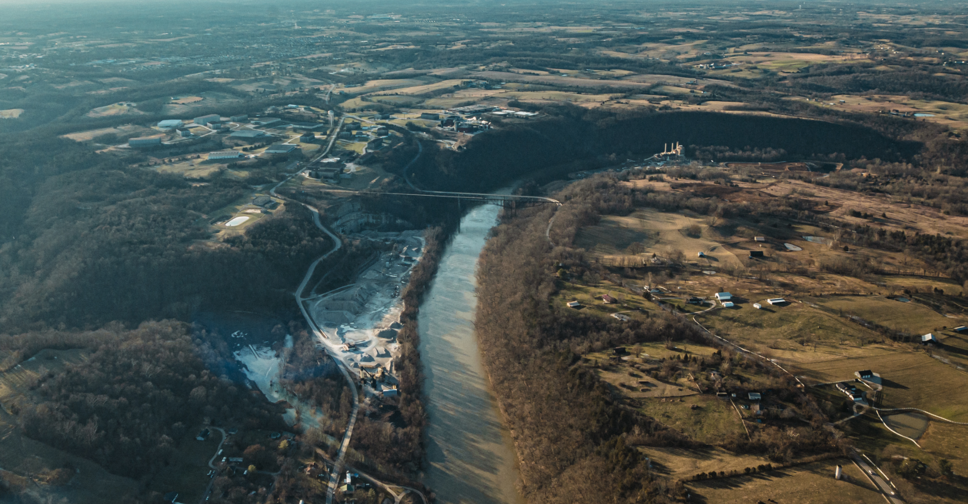 aerial-shot-beautiful-roads-river-field-with-sunny-blue-sky